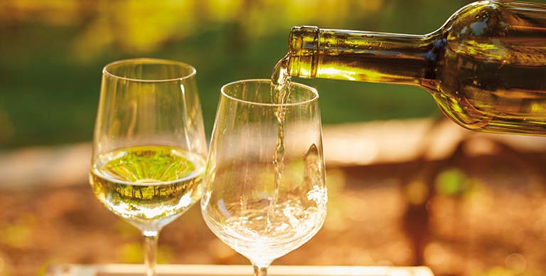 White wine being poured into glasses